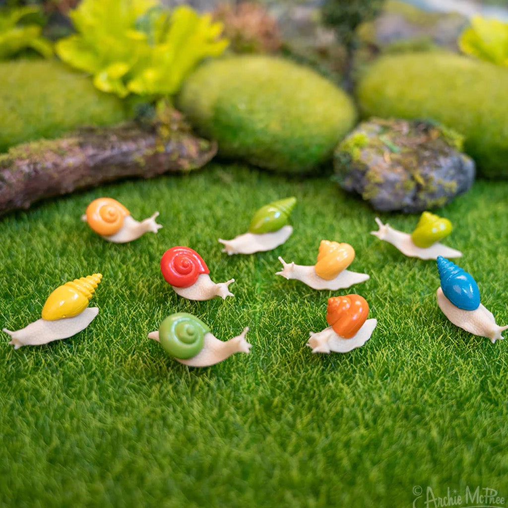 Itty Bitty Snails on grass.