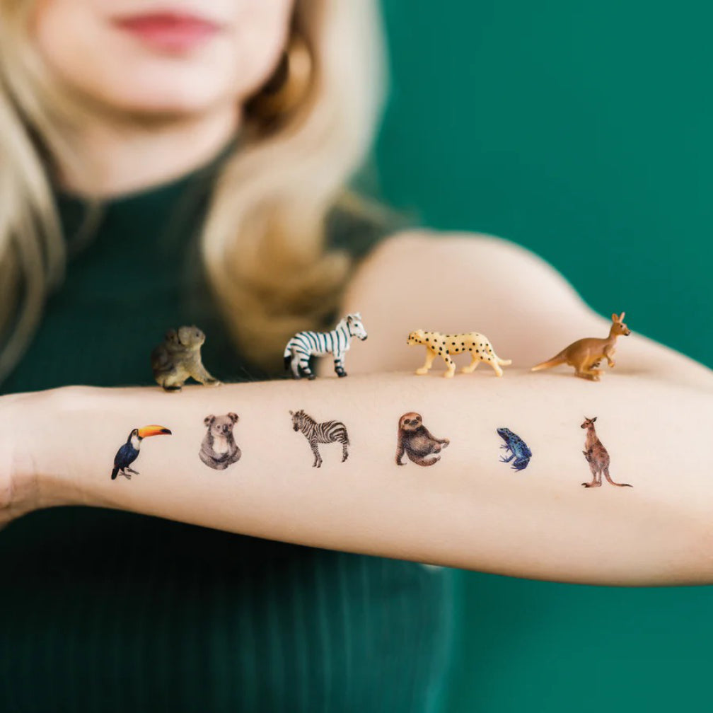 Mini Animal Kingdom Tattoos on arm.