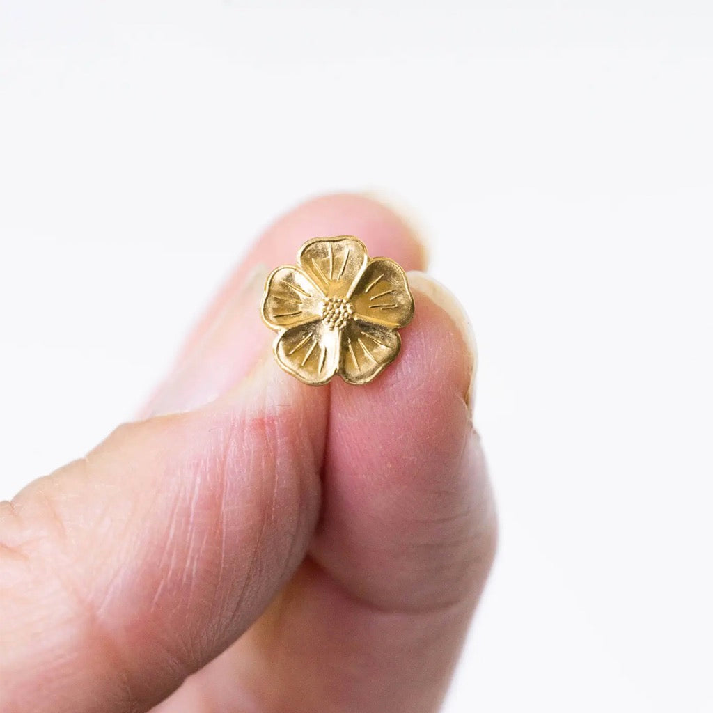 Mini Flower Studs being held.