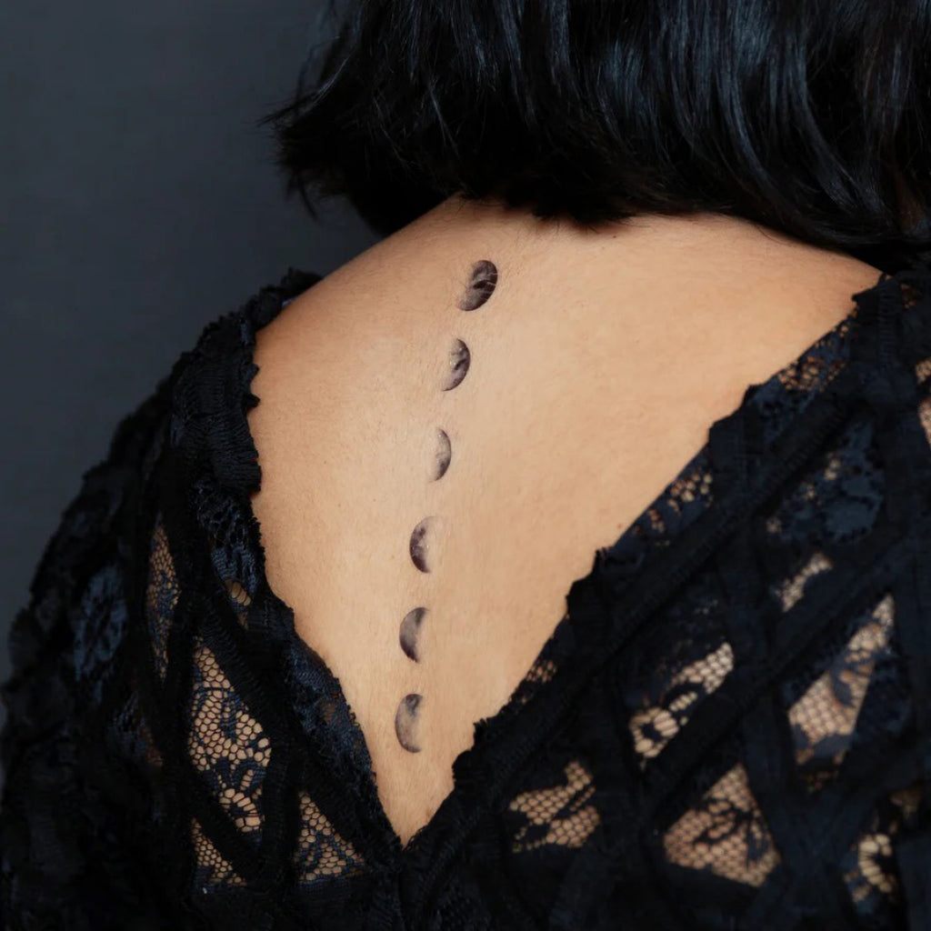 Moon Phases Tattoos on back.