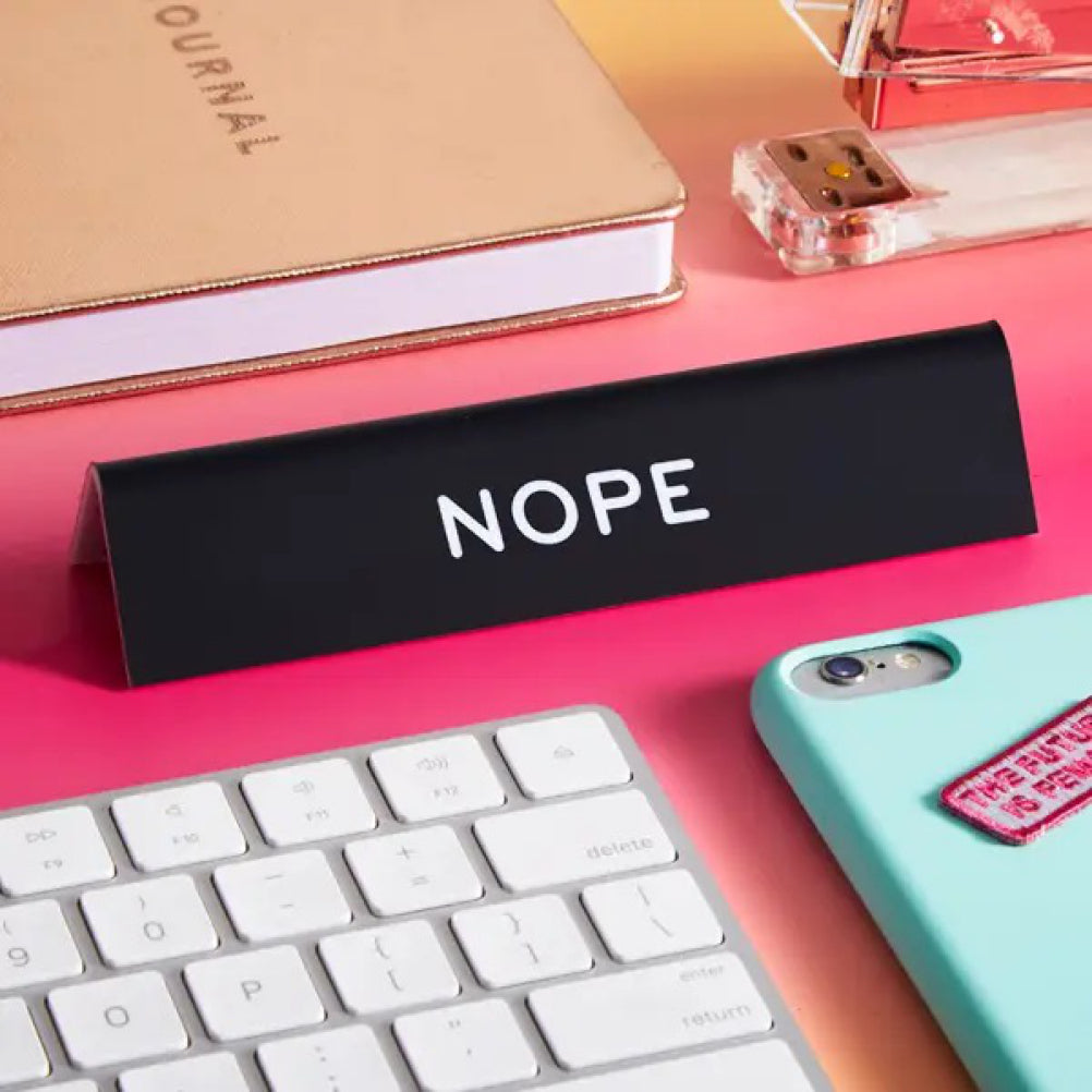 NOPE Desk Sign on table.