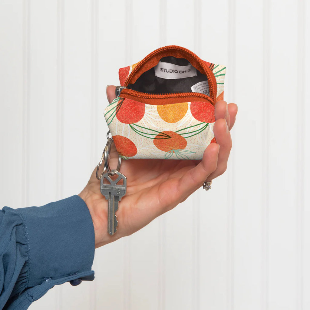 Orange Whimsy Key Chain Pouch in hand.