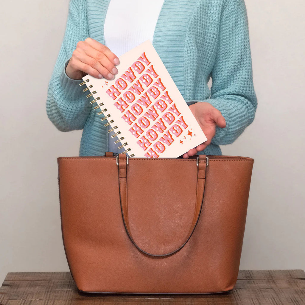 Person holding Howdy Partner Medium Spiral Notebook.