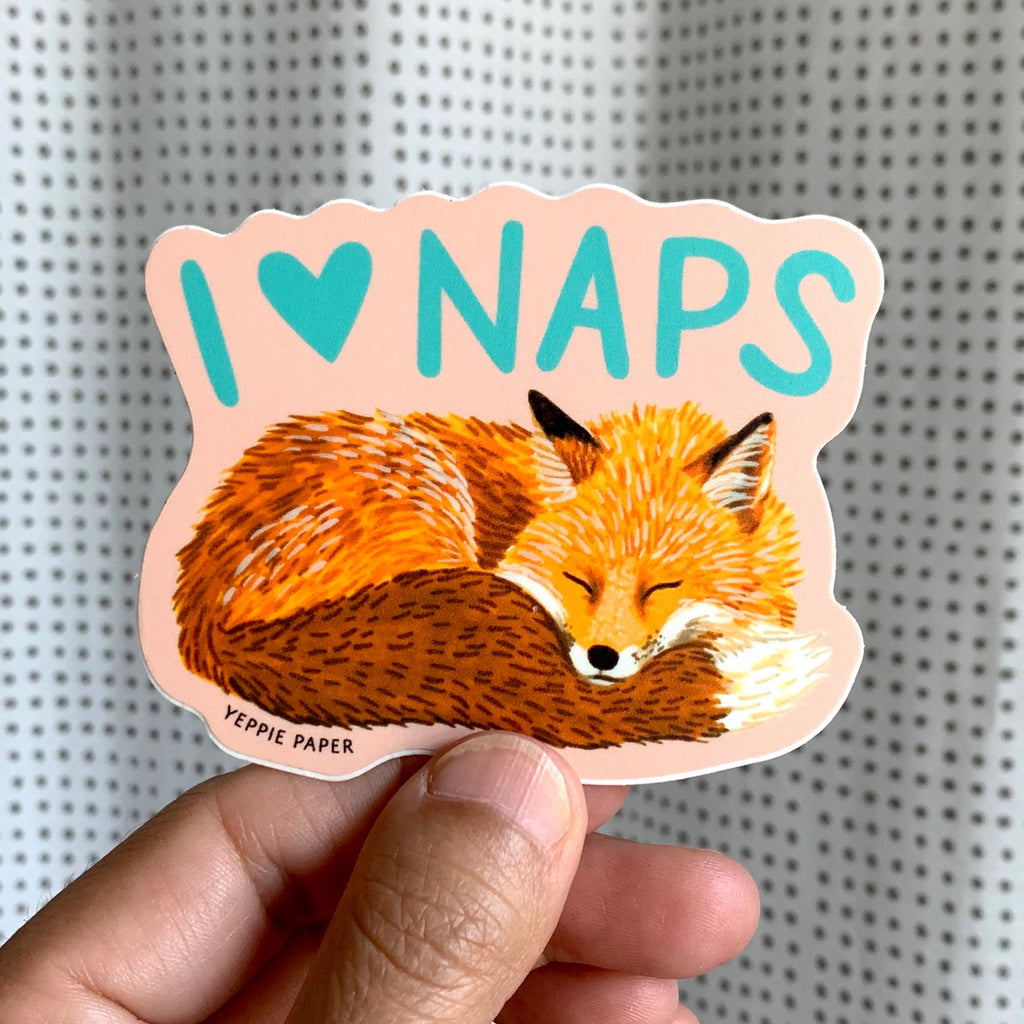 Person holding Napping Fox Sticker.