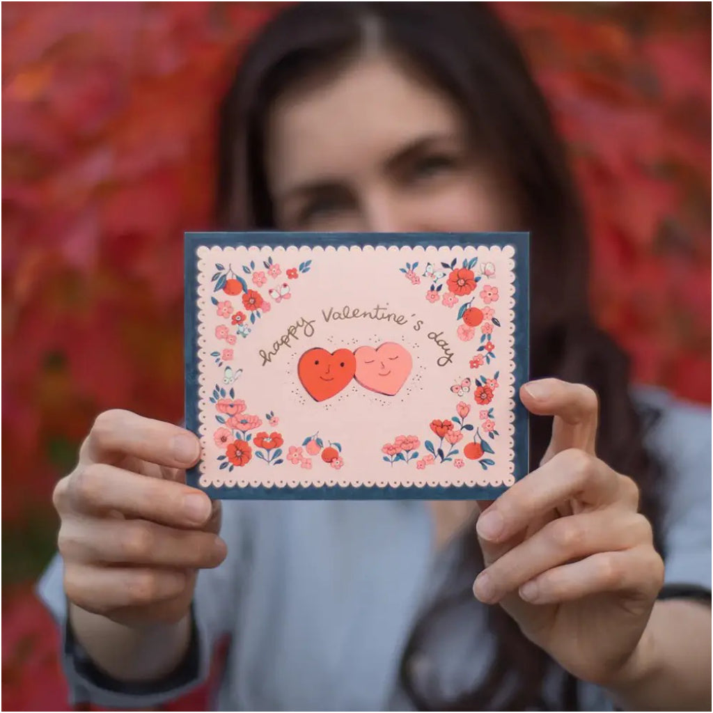 Person holding Valentine Hearts Card.