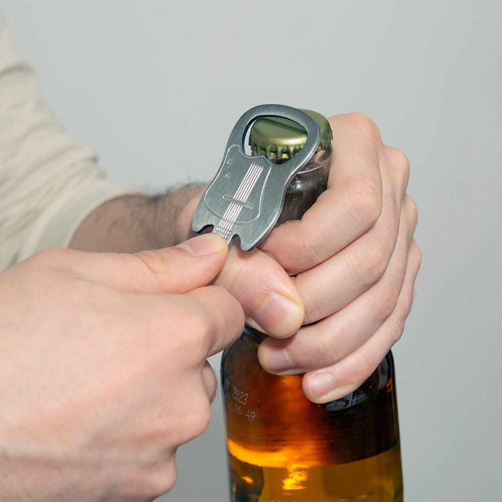 Person using Guitar Keychain Bottle Opener.