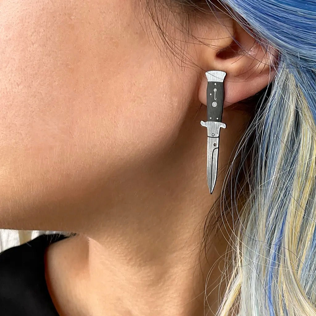 Person wearing A Knife Less Ordinary Stud Earrings.