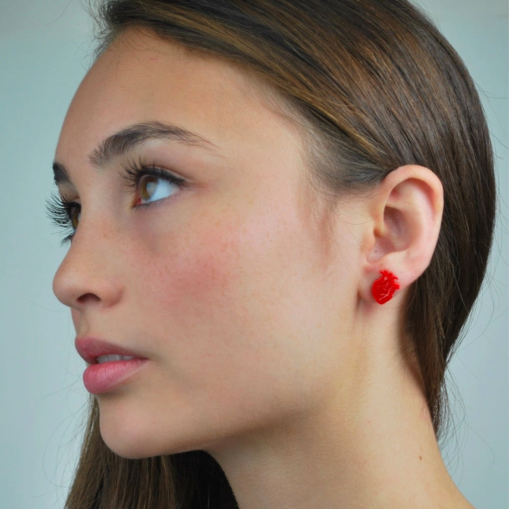 Person wearing Anatomical Heart Studs Solid Red.