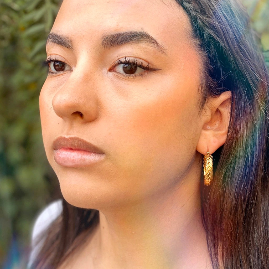 Person wearing Braided Hoops.