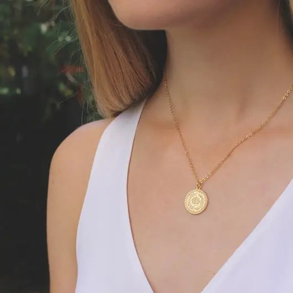 Person wearing Crown Coin Necklace.