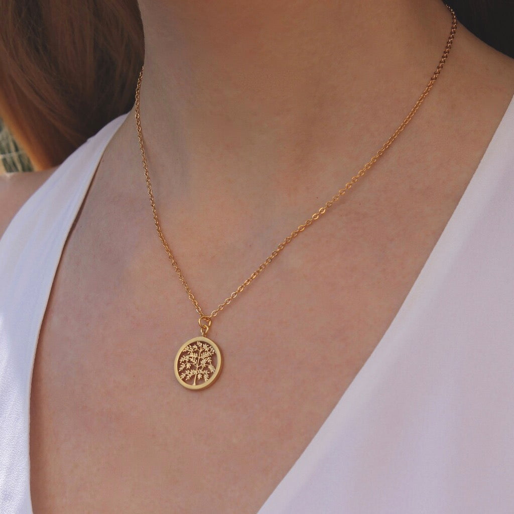 Person wearing Gold Tree Necklace.
