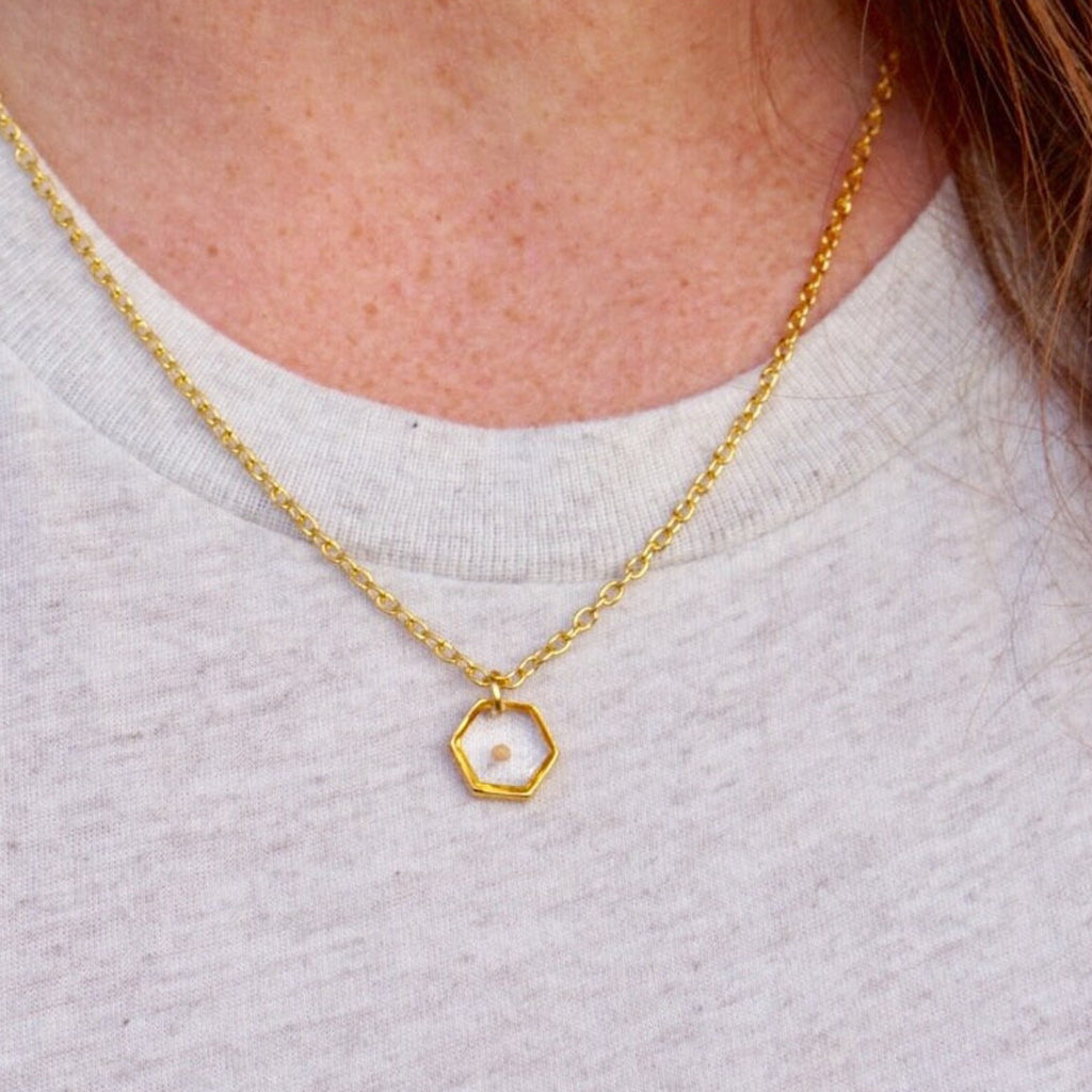 Person wearing Hexagon Gold Plated Mustard Seed Necklace.