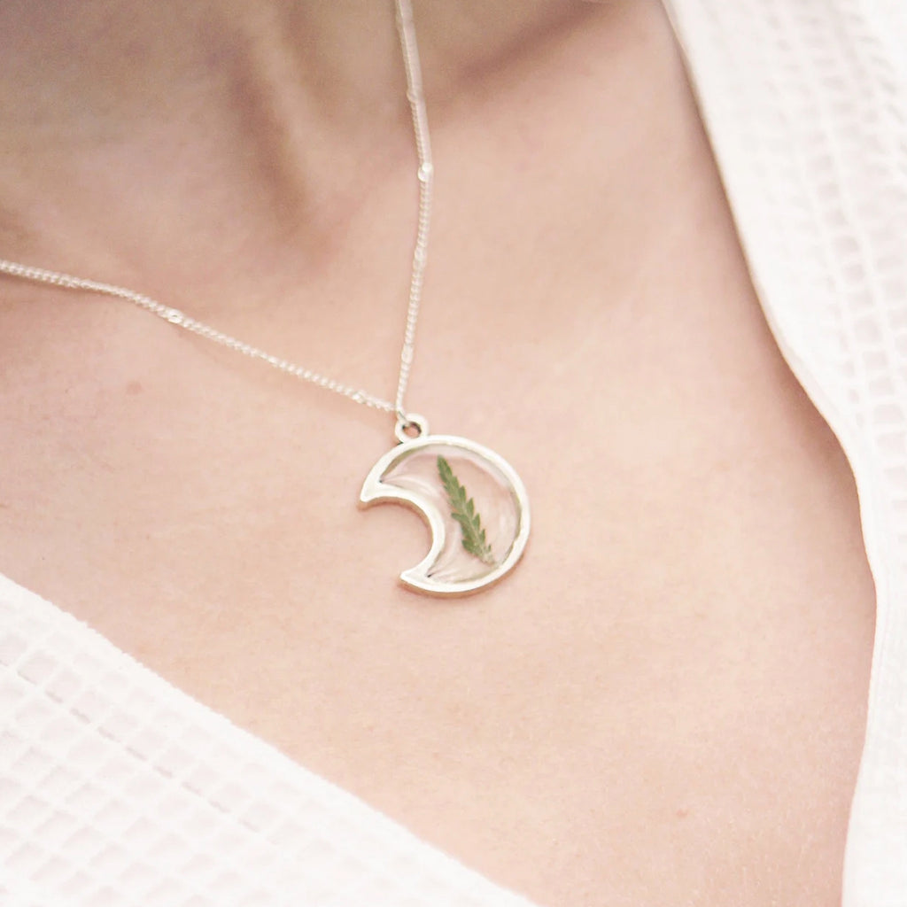 Person wearing Moon Fern Necklace Silver Plated.
