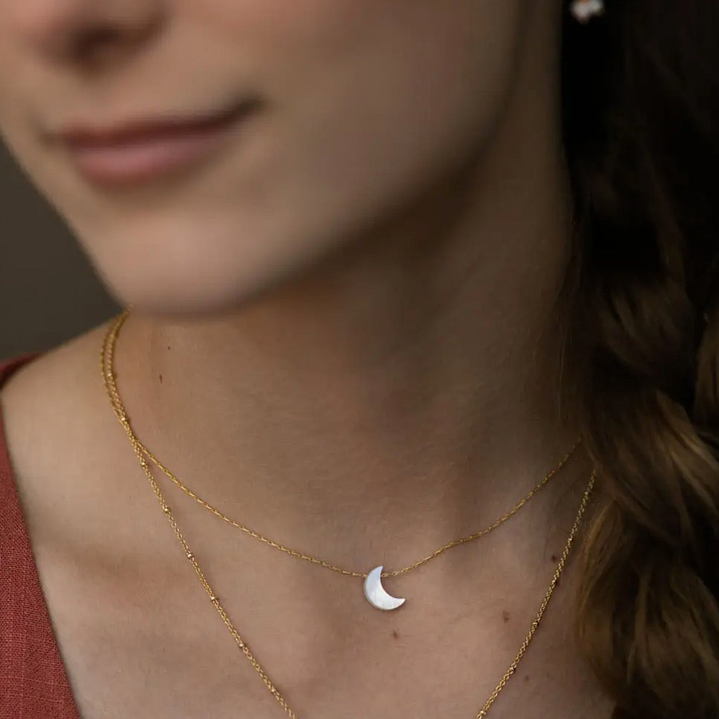 Person wearing Mother of Pearl Moon Necklace.