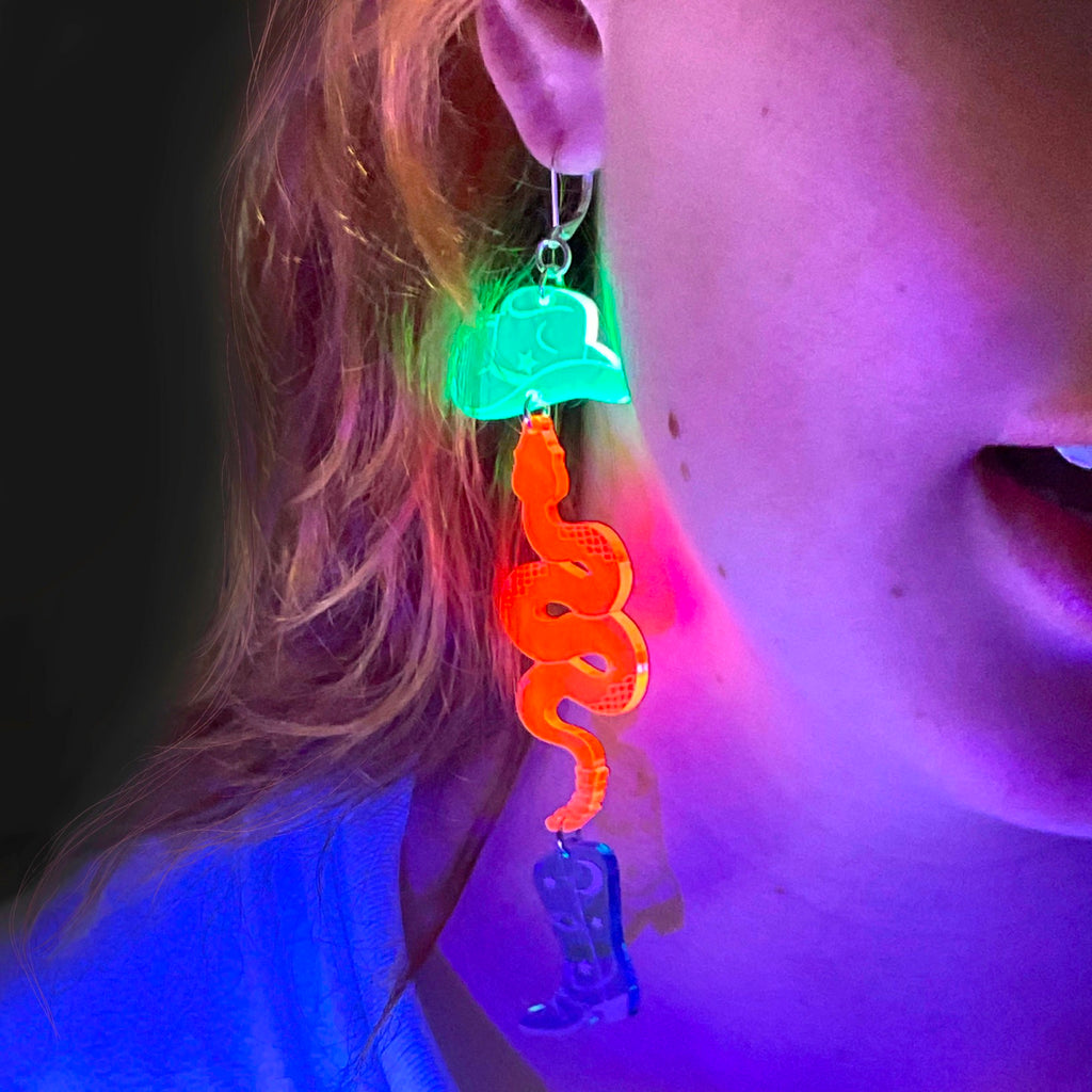 Person wearing Neon Cowboy Earrings.