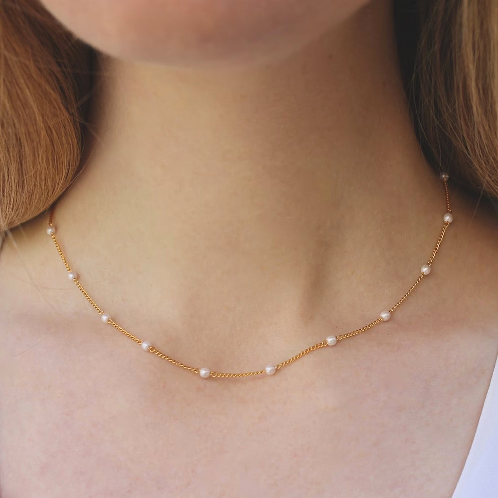 Person wearing Pearl Chain Layering Necklace.