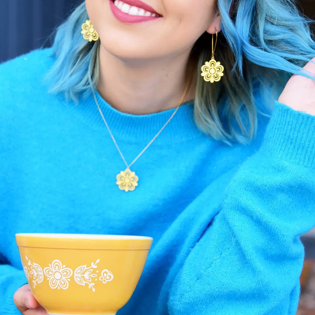 Person wearing Retro Pyrex Flower Necklace Butterfly Gold Pattern.