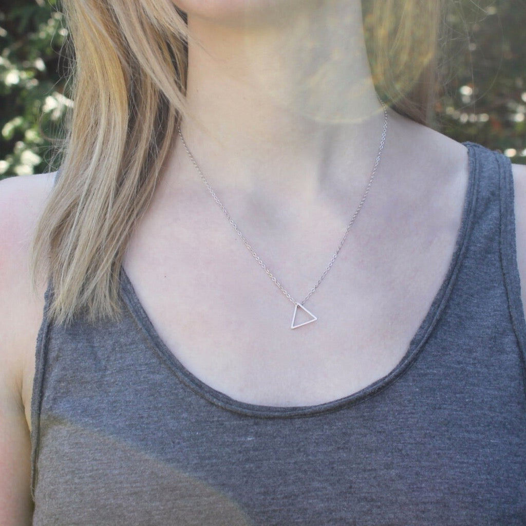 Person wearing Silver Little Triangle Necklace.
