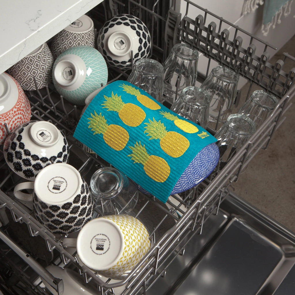 Pineapples Swedish Dishcloth being put in dishwasher.