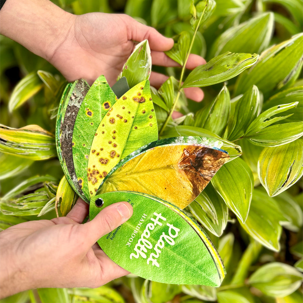 Plant Health Handbook in hand.