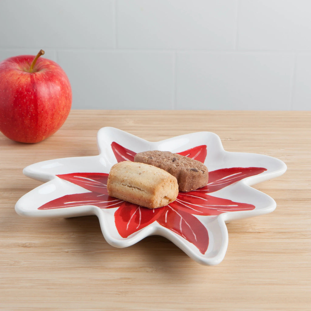 Poinsettia shaped dish with cookies in it.