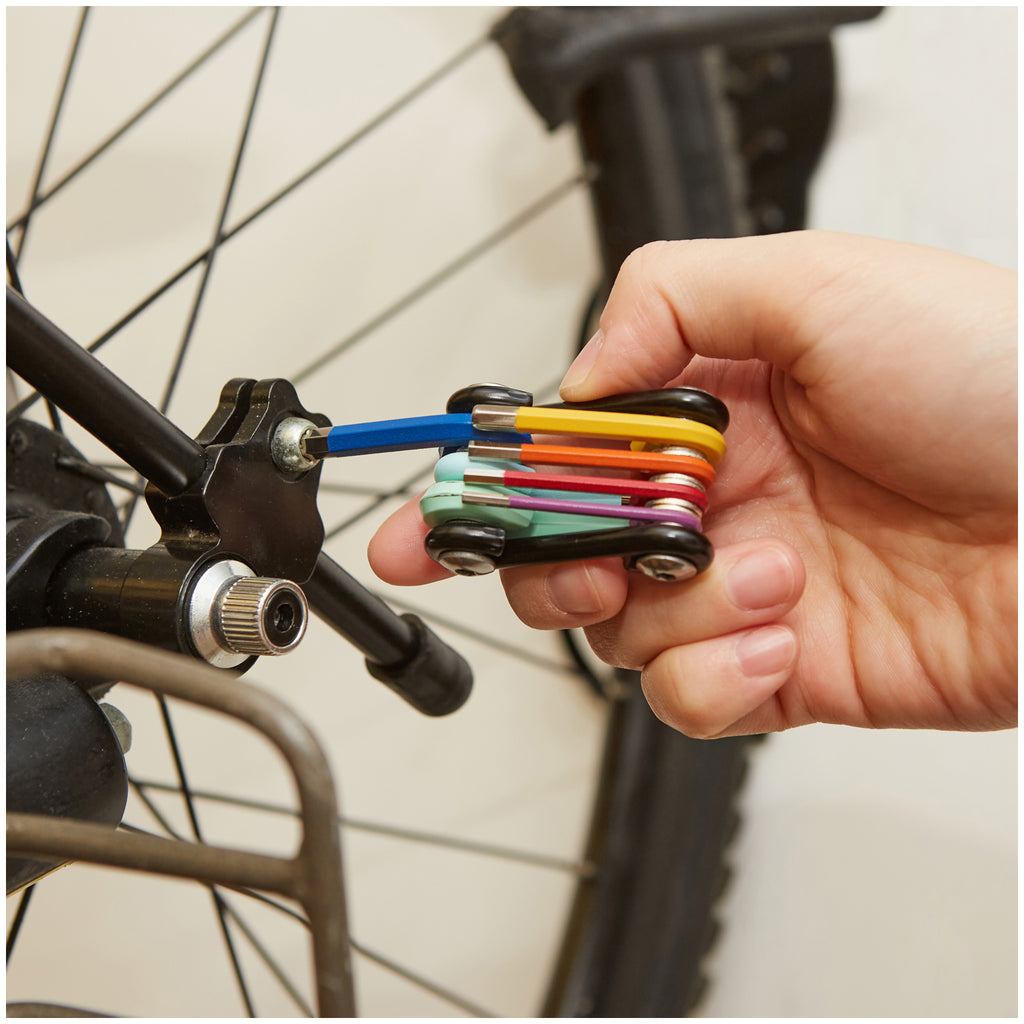 Rainbow 7-in-1 Cyclist Multitool being used on a bike.
