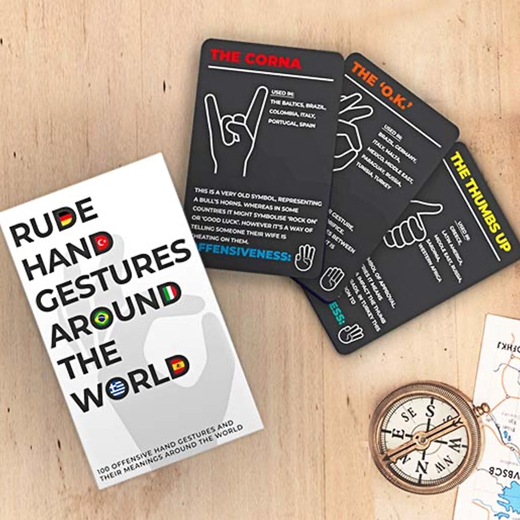 Rude Hand Gestures Around The World cards and packaging on table.