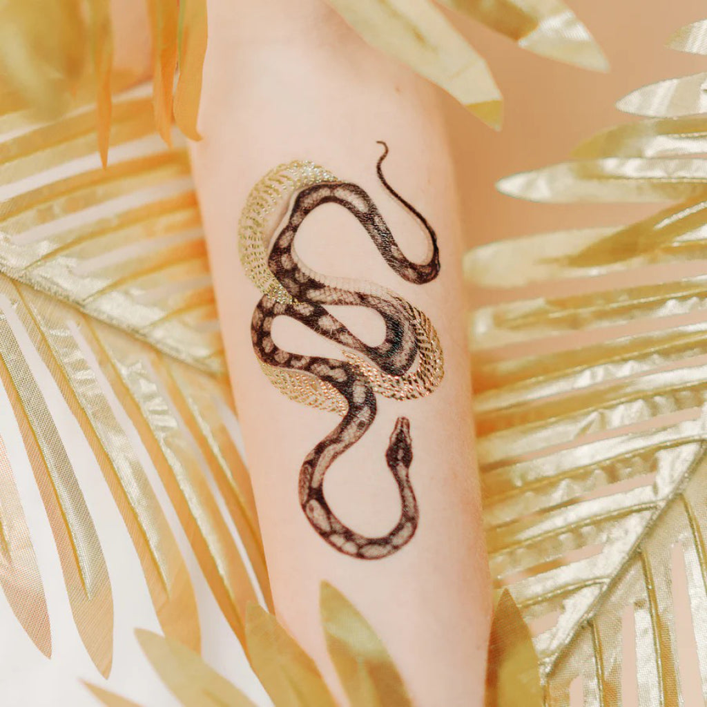 Shimmering Serpent Gold Tattoo closeup.