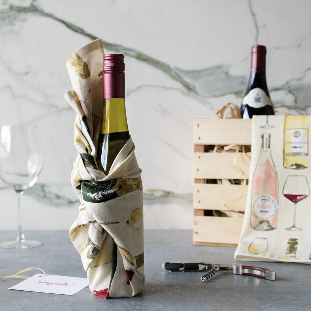 Sommelier tea towel wrapped around bottle of wine.