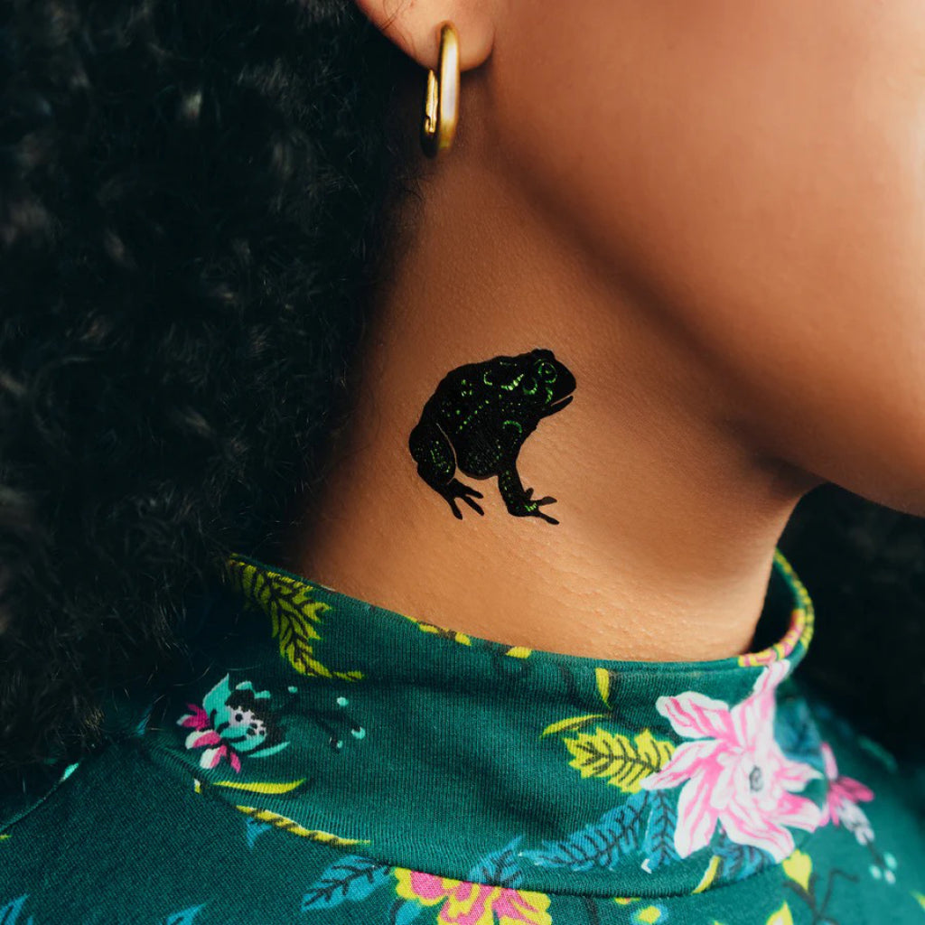 Speckled Metallic Frog Tattoo on neck.