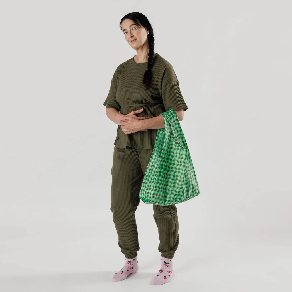 Standard Baggu Wavy Gingham Green being held.