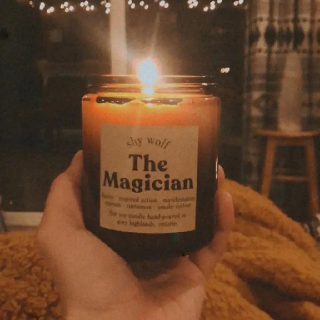 The Magician Tarot Candle being held.