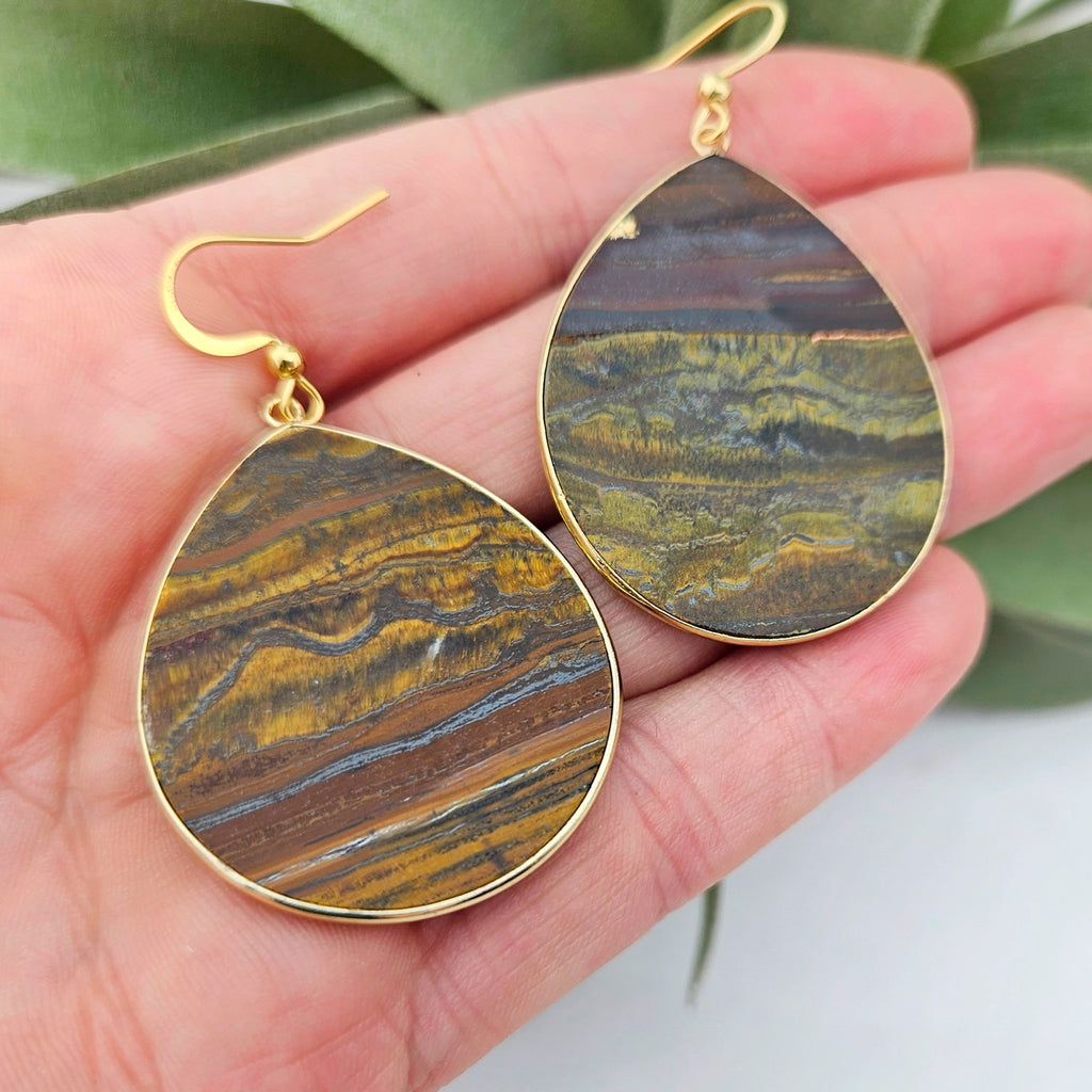 Thin Tigers Eye Teardrop Earrings in hand.