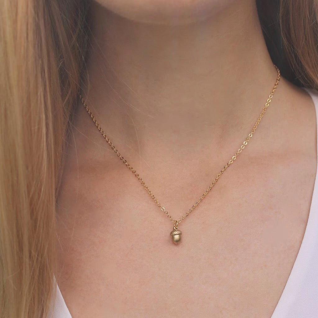 Tiny Acorn Necklace person wearing.