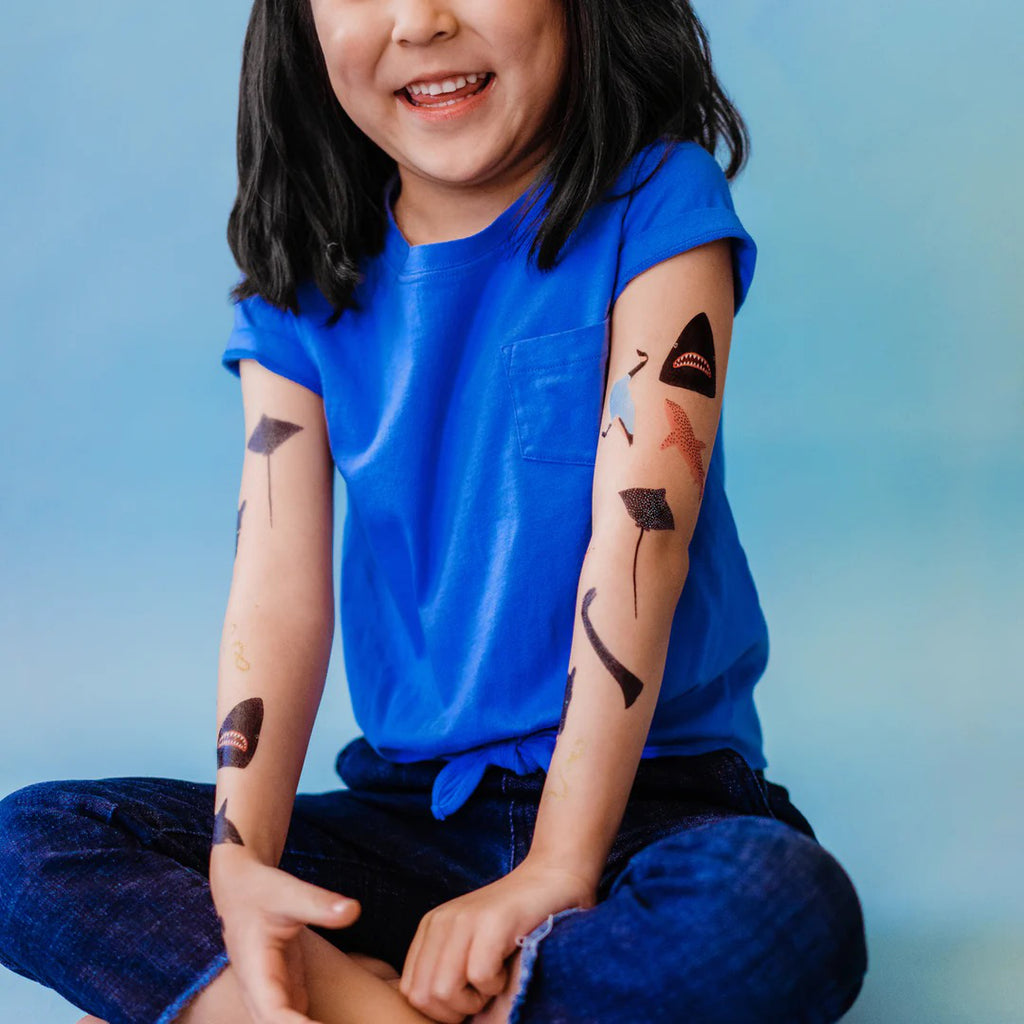 Tiny Animal Tattoos on arms.