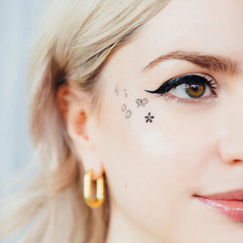 Tiny Nature Tattoos on face.