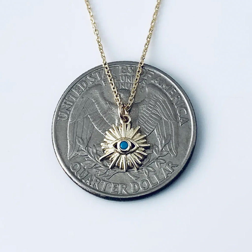 Turquoise Evil Eye Necklace on coin.